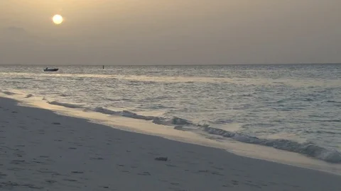 Yellow sunset over ocean from beach Stock Footage 74088504