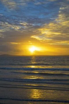 Yellow sunset rays from beal beach Stock Photos