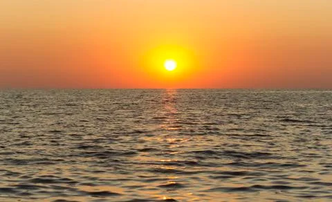 Yellow sunset on the sea Stock Photos