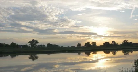 Yellow Sunset's Reflection in Smooth Water, Pond, River, Cloudy Sky Video stock 50665877