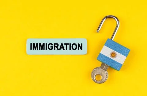 On a yellow surface, an open lock with the image of the flag of Argentina wit Stock Photos