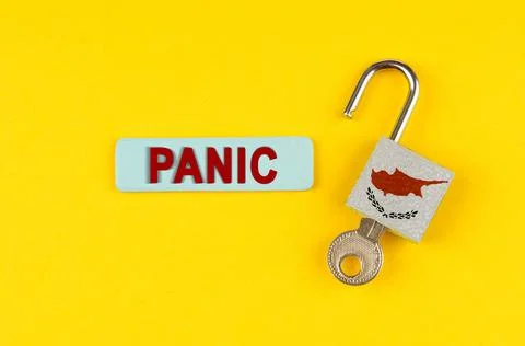 On the yellow surface is an open lock with a key and a sticker with the ins.. Stock Photos