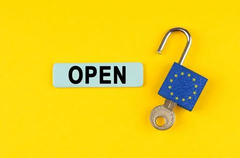 On a yellow surface, an open padlock with the image of the flag of the Europe Stock Photos