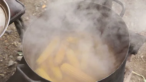 Yellow sweet corn is cooked in a cauldron by a street vendor 1 Video stock 297607841