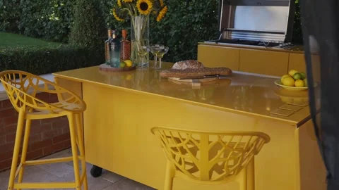 A yellow table with two chairs and a grill Stock Footage 297870404
