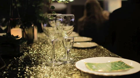 On Yellow Tablecloth Are Two Empty Glasses Stock Footage 62770980