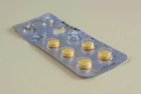 Yellow Tablets in Blister Pack on Light Background Close Up Medicine Concept Stock Photos
