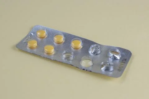 Yellow Tablets in Blister Pack on Light Background Close Up Medicine Concept Stock Photos