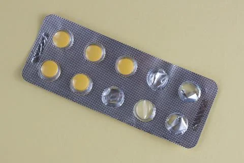 Yellow Tablets in Blister Pack on Light Background Close Up Medicine Concept Stock Photos