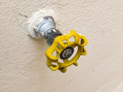 Yellow tap isolated with soft backlight. Foto stock