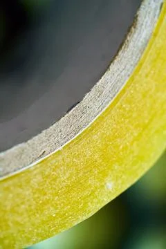 Yellow tape rolls on a work surface Stock Photos