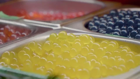 Yellow tapioca pearls for bubble tea, with red and blue toppings Stock Footage 302475147