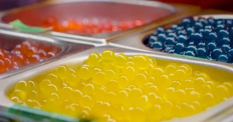 Yellow tapioca pearls for bubble tea, with red and blue toppings Stock Photos