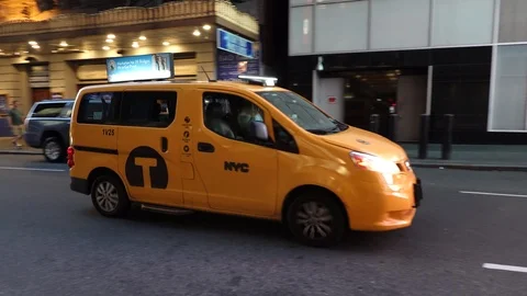 Yellow taxi cab van drives down busy Stock Video Pond5
