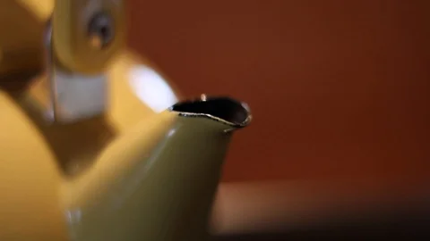 Yellow tea kettle slider shot with focus racking Stock Footage 119796974