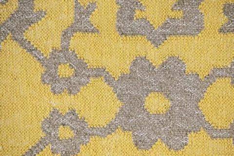 Yellow textile with abstract ethnic pattern close-up and visible texture. Fol Stock Photos