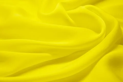 Yellow textile pattern as a background. yellow material texture on fabric Stock Photos