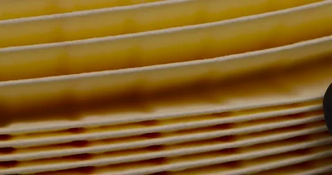 Yellow thin car filter for air filtration, new clean car filter to ensure engine Stock Footage 261094729
