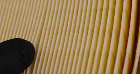 Yellow thin car filter for air filtration, new clean car filter to ensure engine Stock Footage 265097196