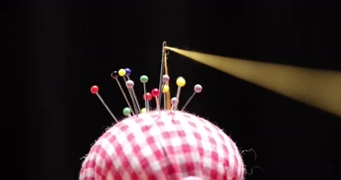 Yellow thread passing through the eye of the needle, close-up Stock Footage 168363914