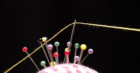 Yellow thread passing through the eye of the needle, close-up Stock Footage 168363957