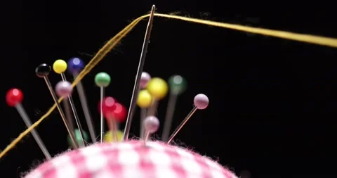 Yellow thread passing through the eye of the needle, close-up Stock Footage 168363977