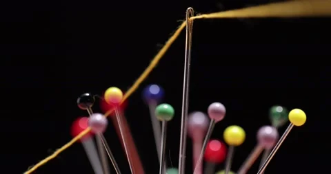 Yellow thread passing through the eye of the needle, close-up Stock Footage 168363997