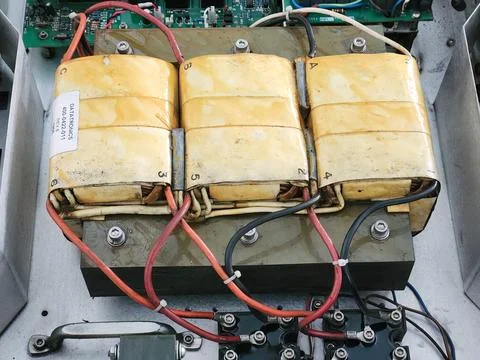 Yellow Three Phase Transformer with Power Cables. Stock Photos