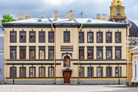 Yellow three-story building. Stock Photos