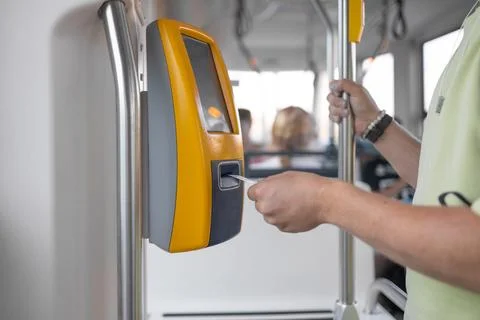 Yellow ticket validation machine on a modern public transport bus. Traveler Stock Photos