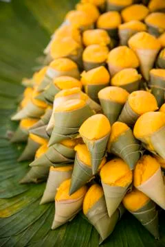 Yellow toddy palm cake in leaf Stock Photos