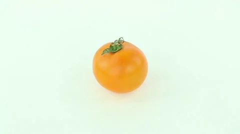 Yellow Tomato rotates on a white background Stock Footage 50032974