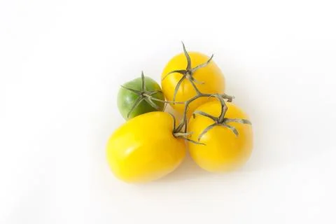 Yellow tomatoes on a white background Stock Photos