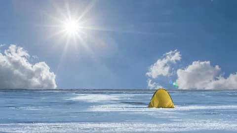 Yellow touristic tent in a winter plain time lapse scene Stock Footage 252131055