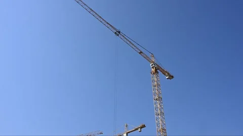 Yellow Tower Crane Against Clear Blue Sky Stock Footage 331582700