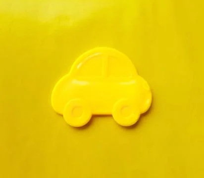 Yellow toy car icon isolated on yellow background Stock Photos