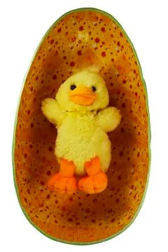 Yellow toy Easter chick in the egg Stock Photos