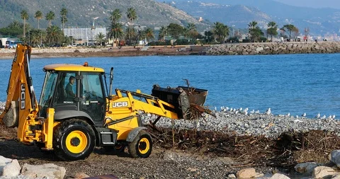 Yellow Tractor Cleans The Beach After A Storm Stock Footage 122335790