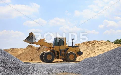 Yellow tractor on construction site Stock Photos