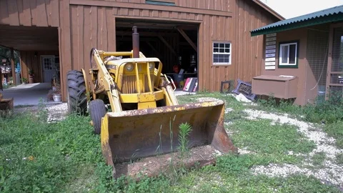 Yellow Tractor in Front of Barn Stock Footage 92547421