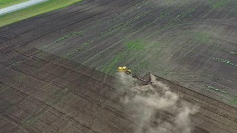 The yellow tractor plows the soil Stock Footage 139856225