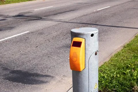 Yellow traffic light button on road background Stock Photos