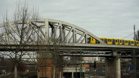 The yellow train of the Berlin U-Bahn passes on a bridge. Stock Footage 224017769