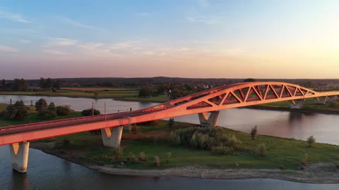 Yellow Train driving over a railway bridge Stock Footage 344391482