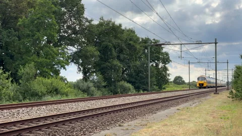 Yellow Train Moving Along Tracks in Netherlands Stock Footage 341563497