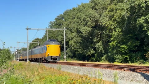 Yellow Train Moving Along Tracks in Netherlands Stock Footage 342111027