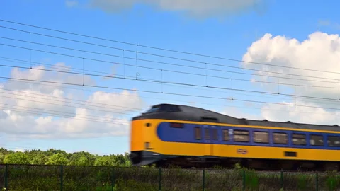 Yellow Train Moving Along Tracks in Netherlands Stock Footage 344394605