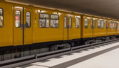 The yellow train at the platform in Berlin Metro Station. Berlin, Germany. Stock Photos