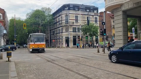 A yellow tram crosses an intersection in Sofia’s historic center, Bulgaria Stock Footage 327603547