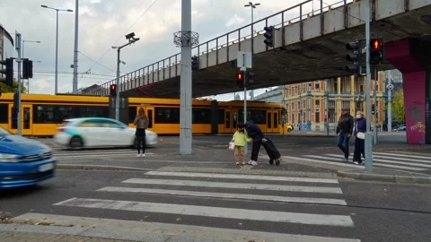 Yellow tram passing through a busy urban intersection in Budapest, Hungary Stock Footage 335070077